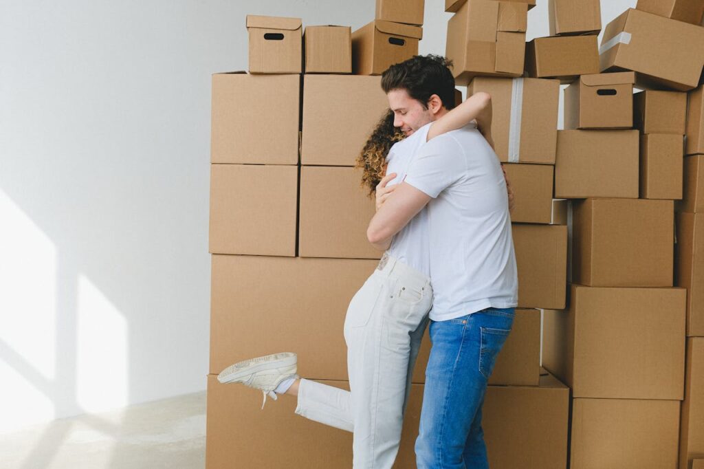 Two people holding cardboard boxes