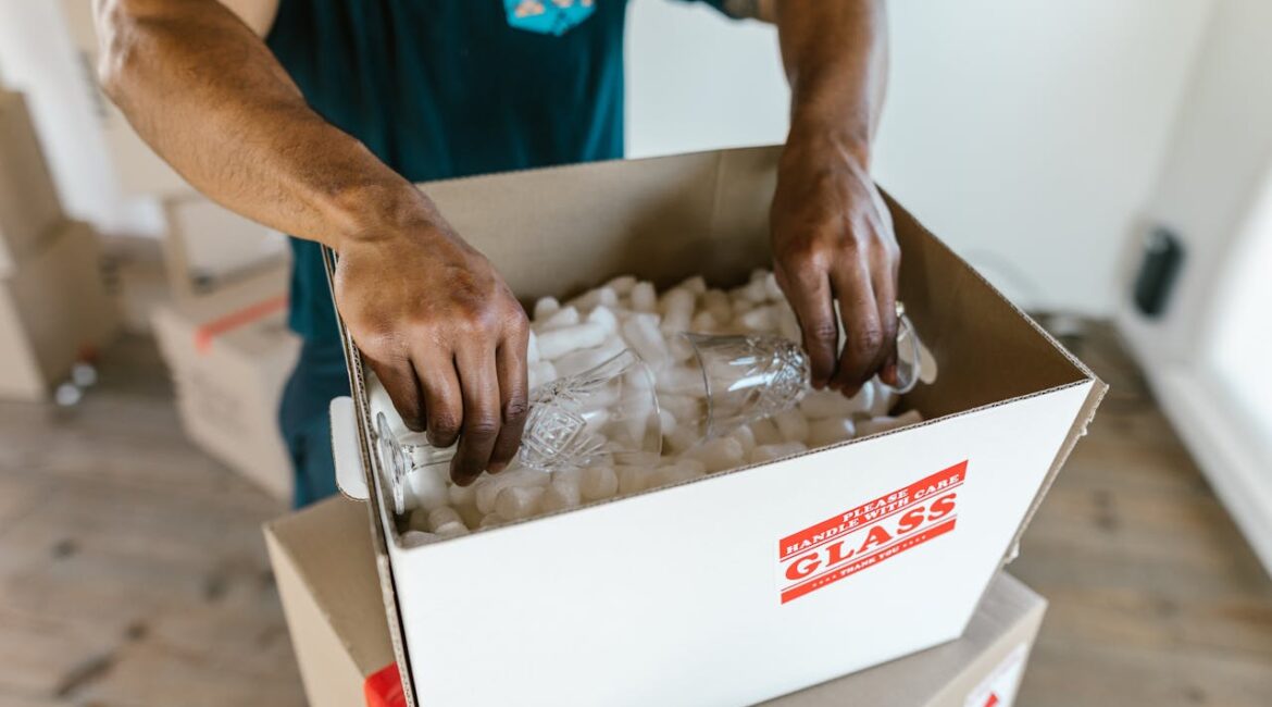 a man putting fragile items in the box.