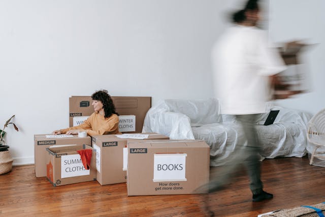 A man and woman packing for relocation.